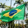 Brazilian flag in front of palm trees